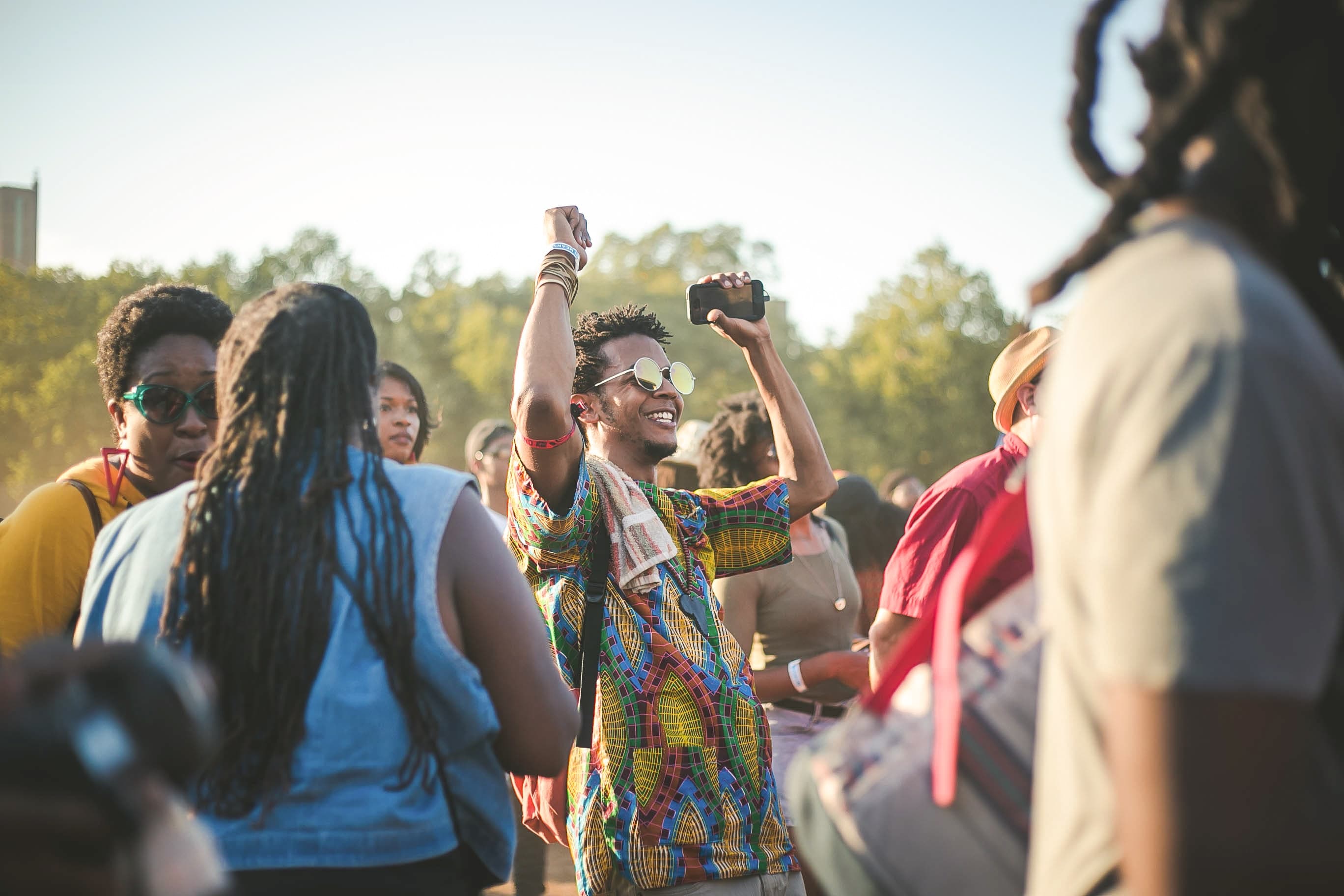 Man met telefoon in zijn hand danst tijdens festival